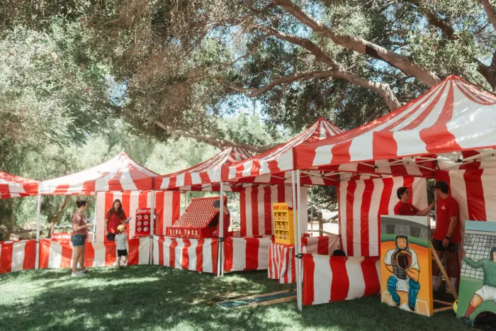 Striped carnival game booth being set up for an event