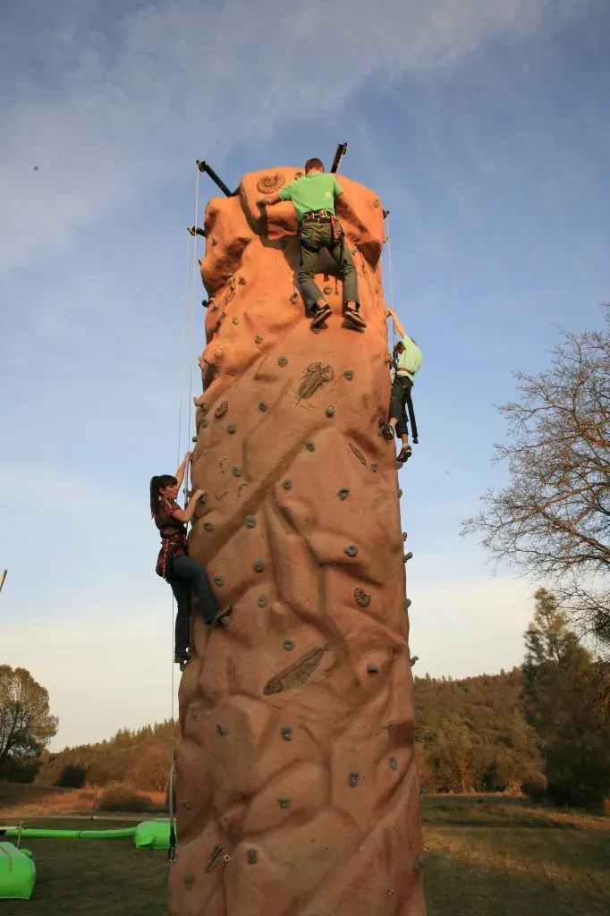 Rock climbing wall attraction at a family carnival event