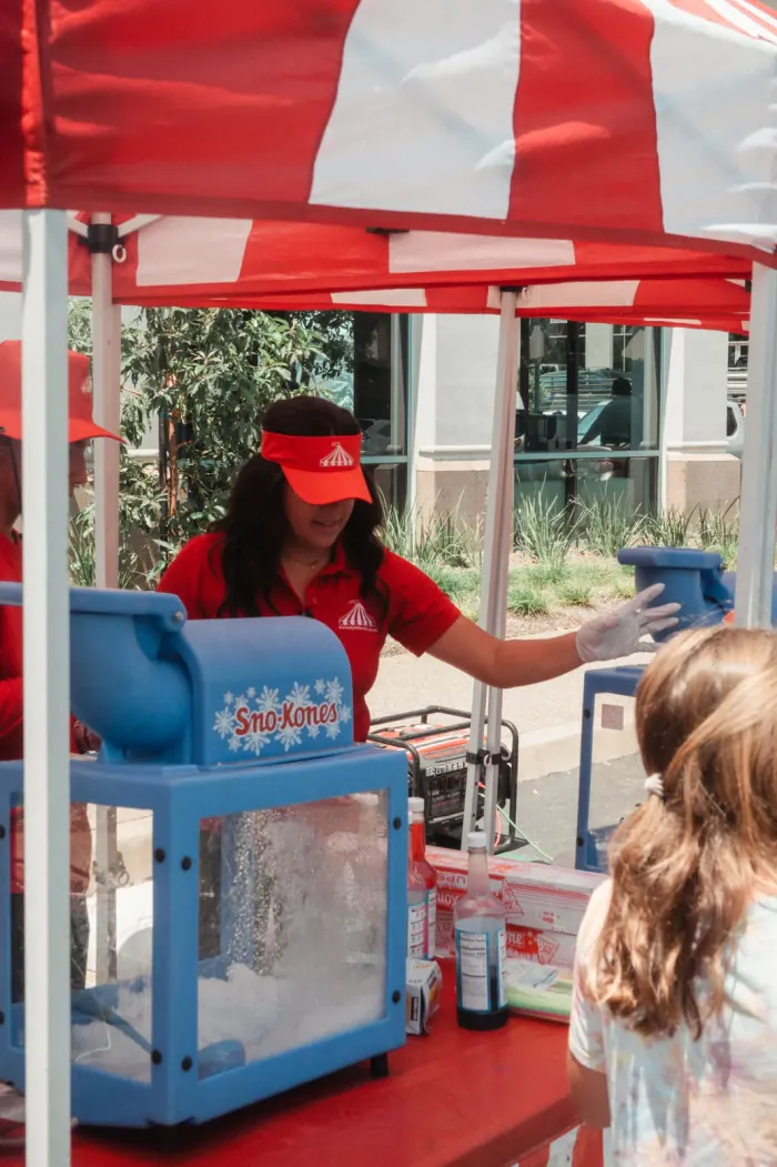 Snow cone concession station serving fresh snow cones at an event