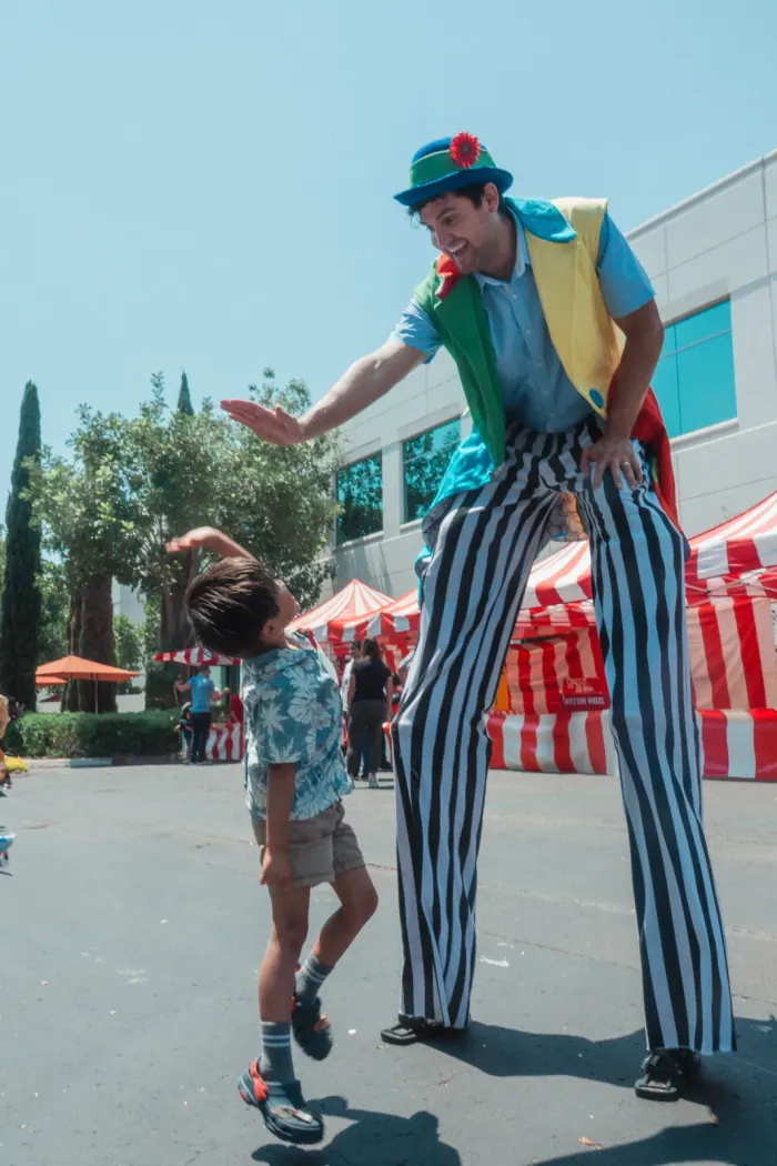 Costumed stilt walker entertainer performing at a carnival event