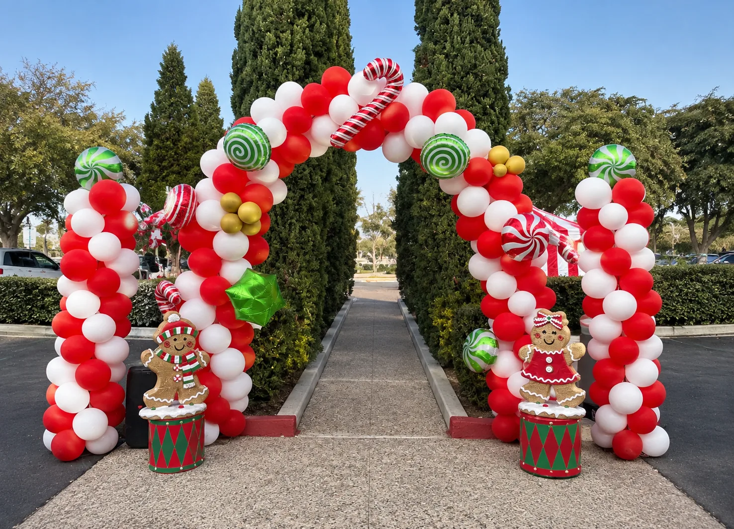 A red-and-white balloon arch trimmed with candy canes, peppermint balloons and gingerbread figures at the entrance to a holiday event